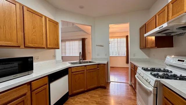 a kitchen with stainless steel appliances a stove a sink and a microwave