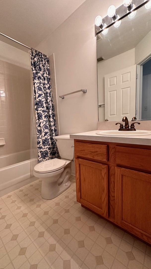 5412 Teaberry Court, Unit 5412 Rolling Meadows, IL 60008 - Photo 7 of 12 a bathroom with a sink a toilet a mirror and shower