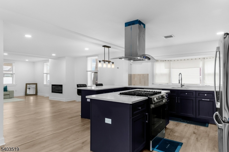15 West Main Street Evesham, NJ 08053 - Photo 11 of 38 a kitchen with stainless steel appliances granite countertop a sink a stove and wooden floor