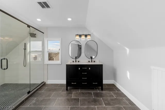 a bathroom with a white bath tub a sink and mirror