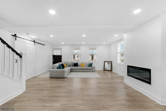 a living room with furniture wooden floor and a flat screen tv