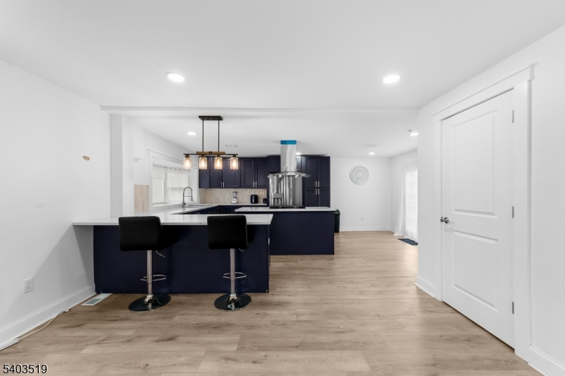 15 West Main Street Evesham, NJ 08053 - Photo 8 of 38 a room with a kitchen island a table and chairs in it