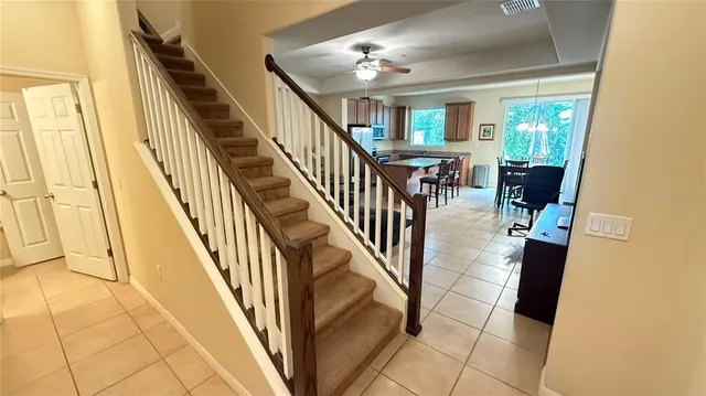 a view of a hallway with wooden floor and staircase