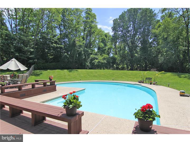 307 Oxford Road Villanova, PA 19085 - Photo 16 of 25 a view of a backyard with a garden and swimming pool
