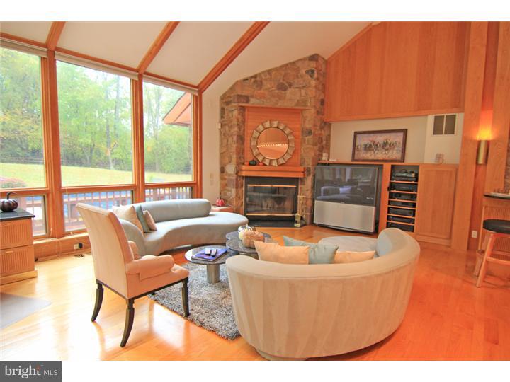 307 Oxford Road Villanova, PA 19085 - Photo 7 of 25 a living room with furniture a large window and a fireplace