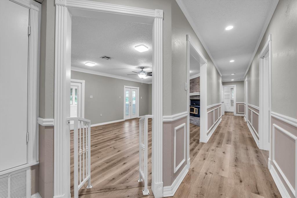 15796 Chapel Road Lorena, TX 76655 - Photo 11 of 34 a view of a hallway with wooden floor and staircase