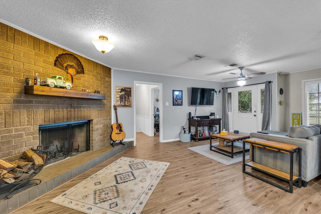 15796 Chapel Road Lorena, TX 76655 - Photo 19 of 34 a living room with furniture and a fireplace