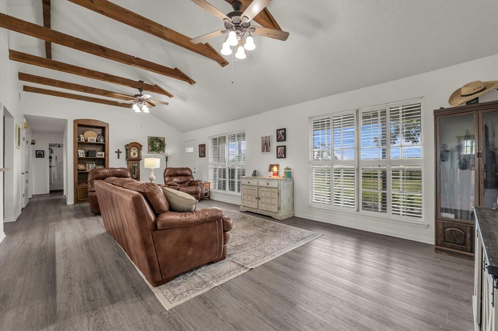 15796 Chapel Road Lorena, TX 76655 - Photo 24 of 34 a living room with furniture a ceiling fan and a flat screen tv