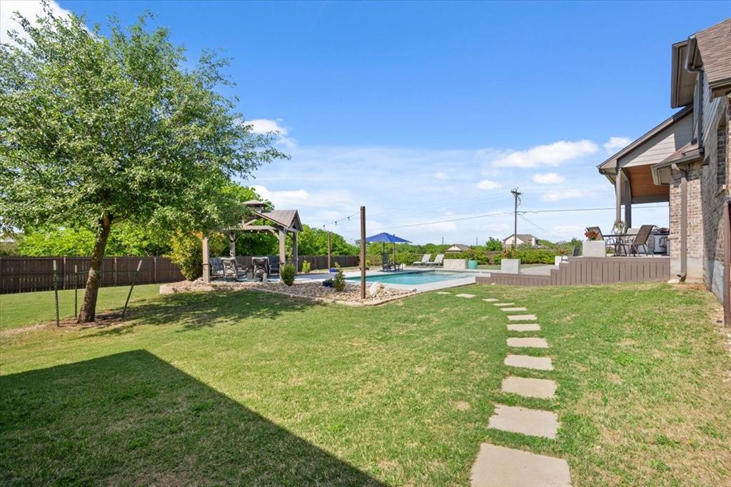 101 Rancho Lorena Drive Lorena, TX 76655 - Photo 38 of 40 a view of a swimming pool with a garden