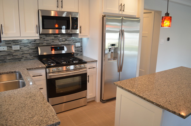 1130 Whitfield Road Northbrook, IL 60062 - Photo 3 of 25 a kitchen with granite countertop a stove and a microwave