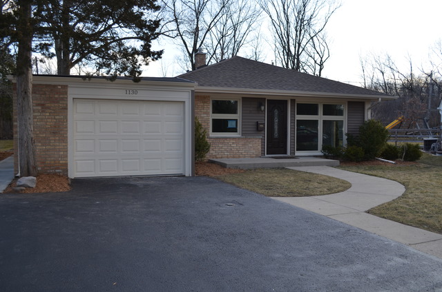 1130 Whitfield Road Northbrook, IL 60062 - Photo 25 of 25 a front view of a house with a yard and garage