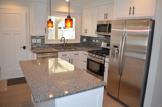 1130 Whitfield Road Northbrook, IL 60062 - Photo 4 of 25 a kitchen with stainless steel appliances granite countertop a sink a stove and a refrigerator