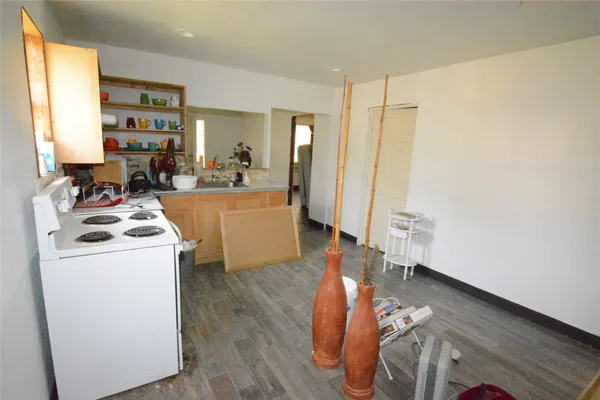 a view of a kitchen with wooden floor and furniture
