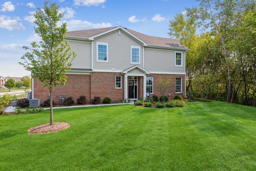 1237 Draper Road McHenry, IL 60050 - Photo 13 of 14 a front view of a house with a garden