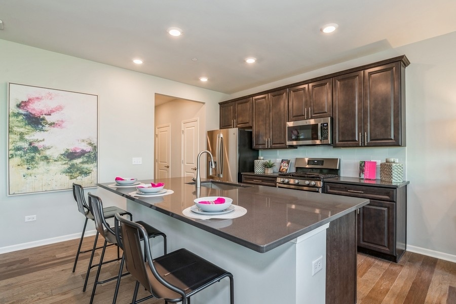 1237 Draper Road McHenry, IL 60050 - Photo 2 of 14 a kitchen with a dining table cabinets appliances and wooden floor