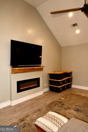 a living room with a flat screen tv and a fireplace