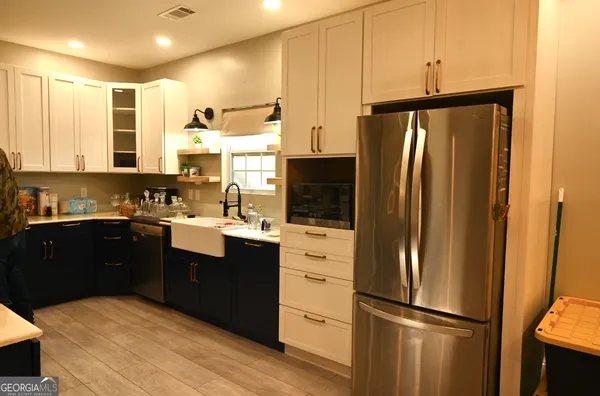 a kitchen with stainless steel appliances granite countertop a refrigerator and a sink