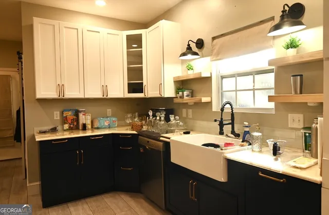 a kitchen with a sink a window and cabinets