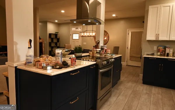 a kitchen with stainless steel appliances a sink stove and cabinets