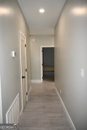 a view of hallway with wooden floor