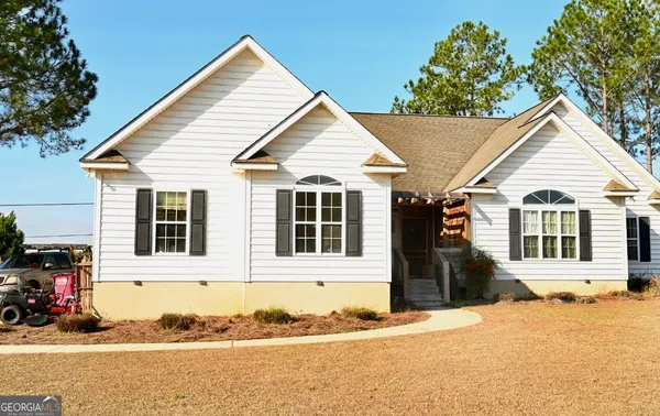 a front view of a house with a yard