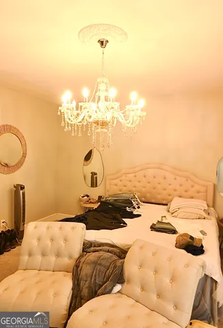 a bed with white sheets and pillows on it