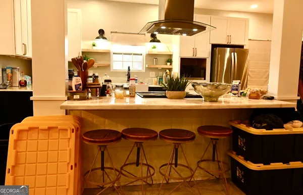 a kitchen with a table and chairs in it