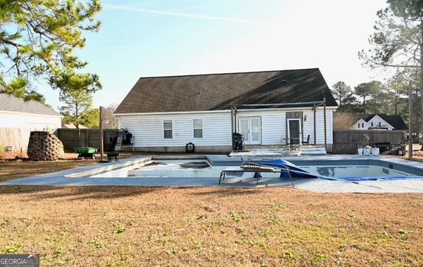a view of a house with swimming pool and sitting area