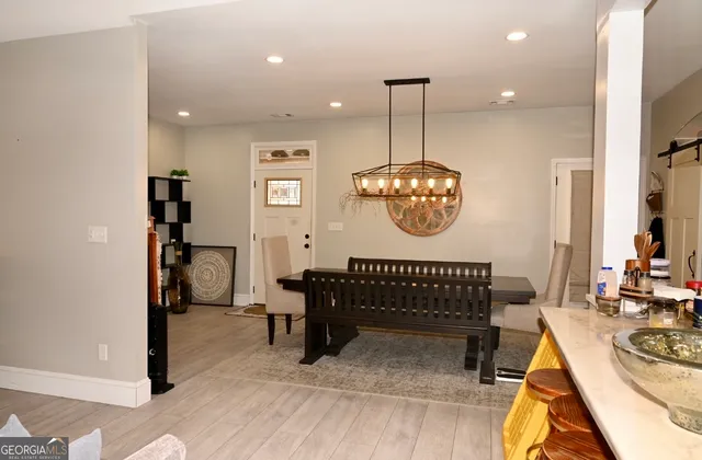 a view of a room that has a bed and a table in it