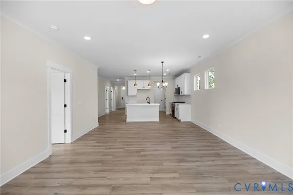 a view of a kitchen with a sink and wooden floor