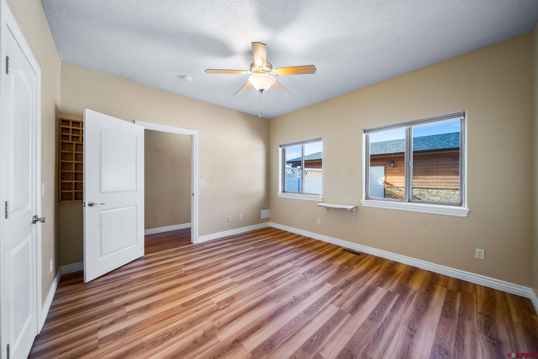 1630 Gateway Drive, Unit 3 Cortez, CO 81321 - Photo 19 of 34 wooden floor in an empty room with a window