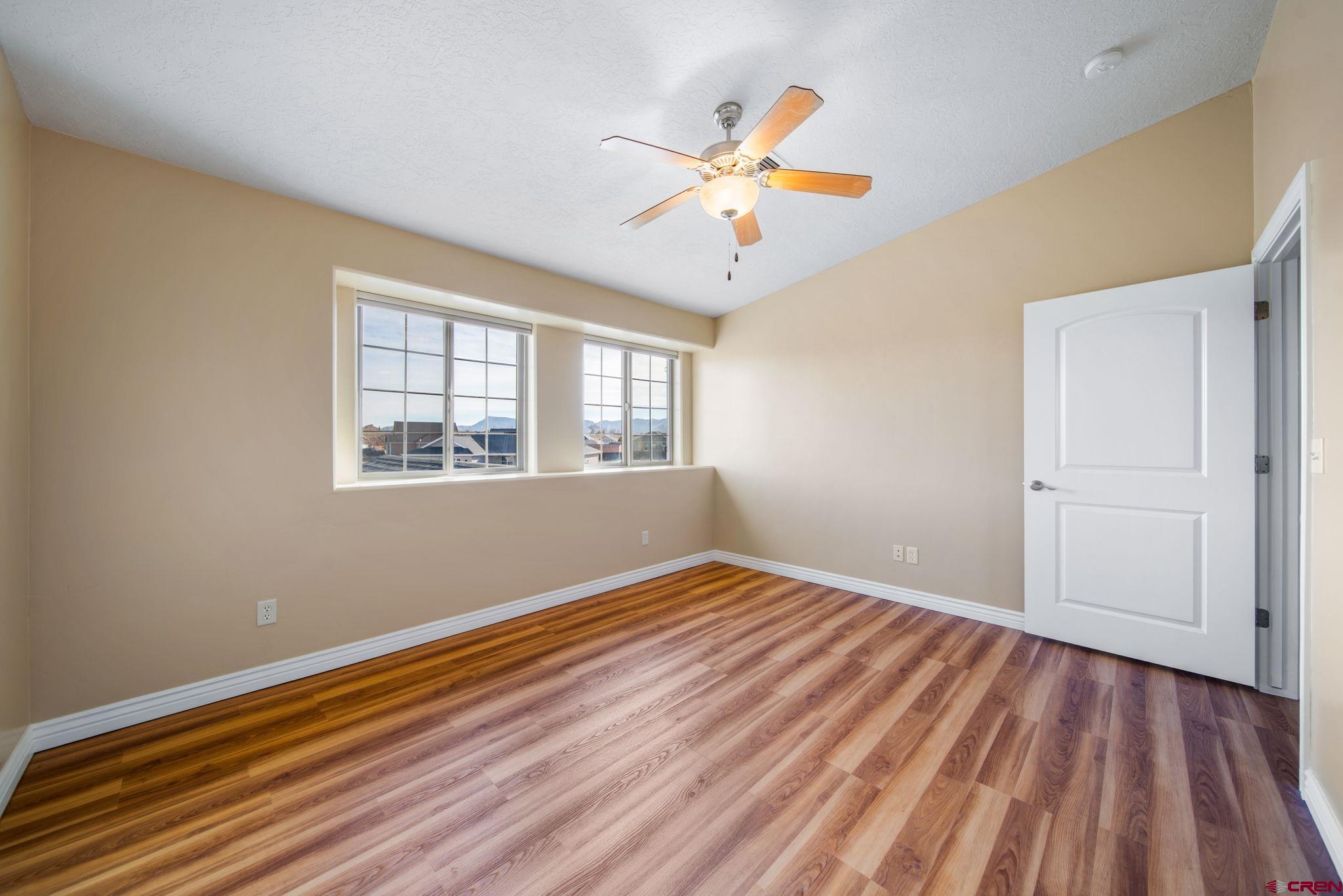 1630 Gateway Drive, Unit 3 Cortez, CO 81321 - Photo 22 of 34 a view of empty room with wooden floor and fan