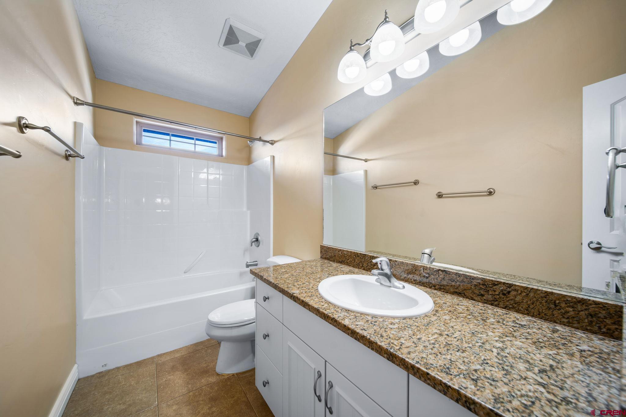 1630 Gateway Drive, Unit 3 Cortez, CO 81321 - Photo 25 of 34 a bathroom with a granite countertop sink a toilet and shower