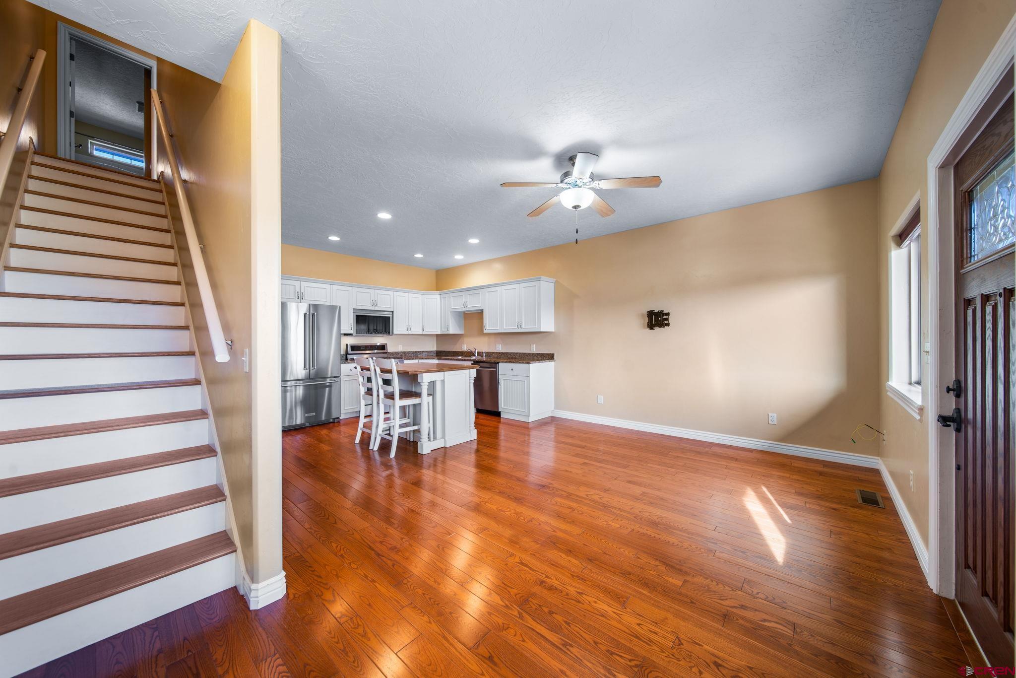 1630 Gateway Drive, Unit 3 Cortez, CO 81321 - Photo 8 of 34 wooden floor in an empty room with a window