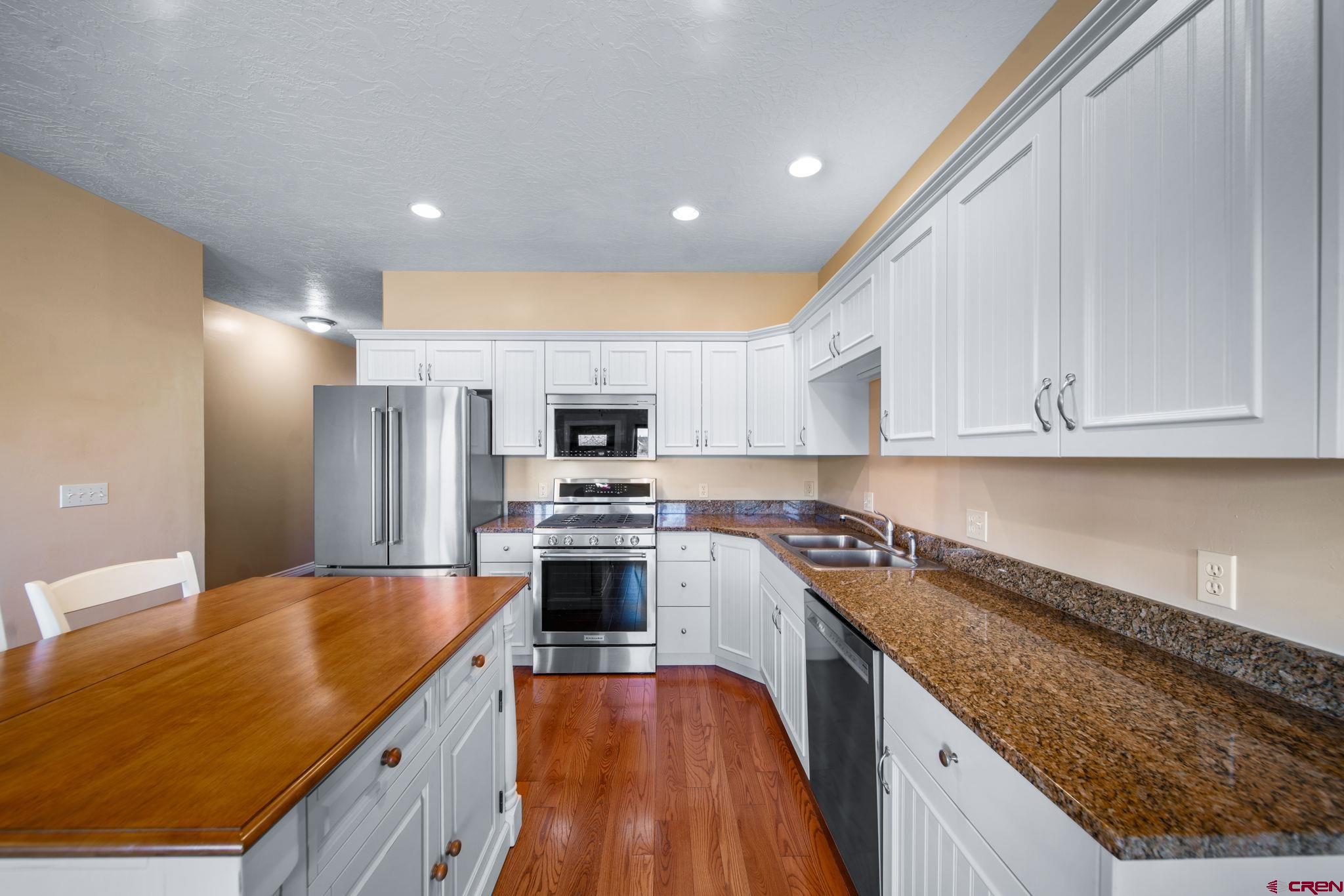 1630 Gateway Drive, Unit 3 Cortez, CO 81321 - Photo 9 of 34 a kitchen with stainless steel appliances granite countertop a sink stove and refrigerator
