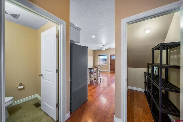 a view of a hallway with wooden floor and furniture