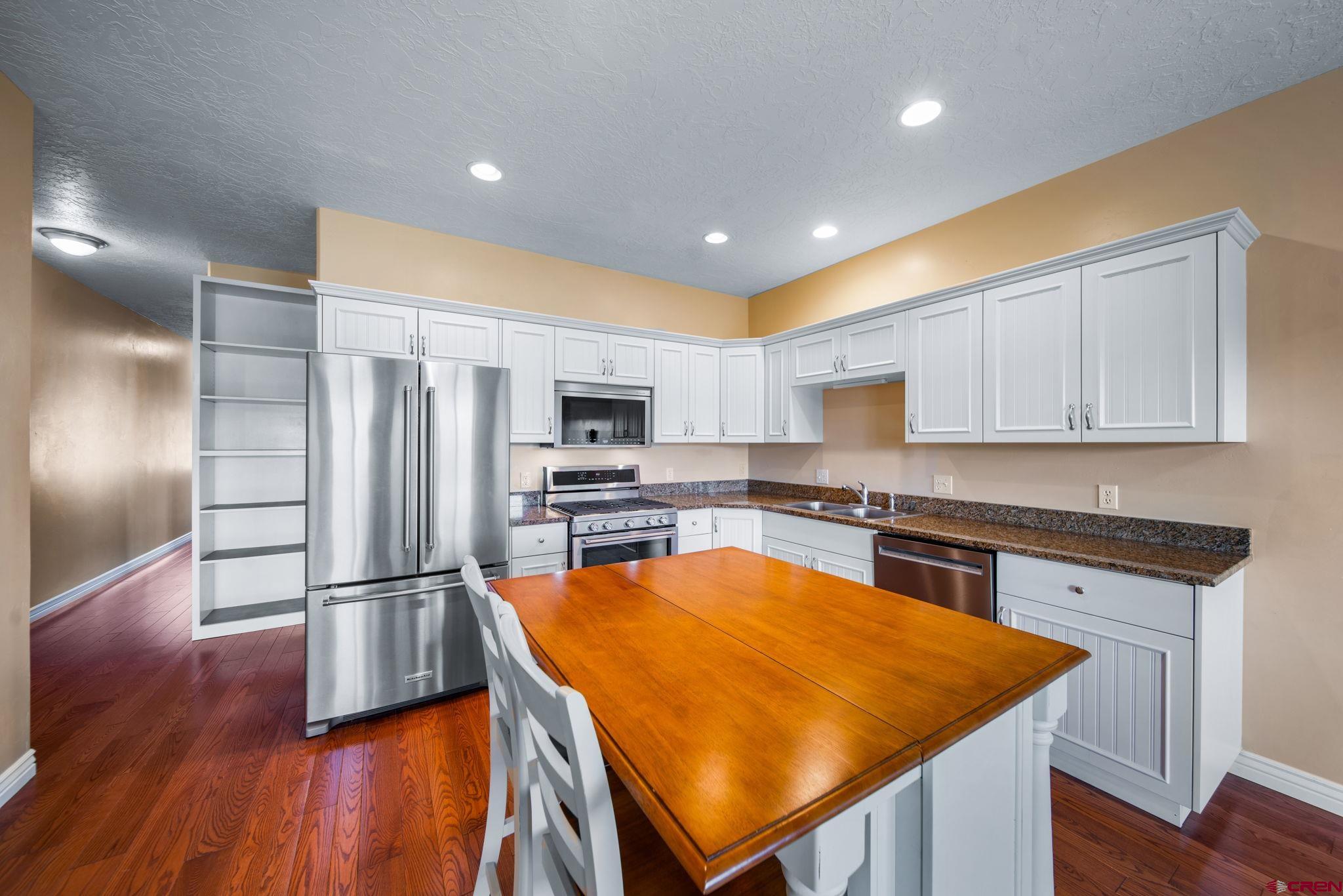 1630 Gateway Drive, Unit 3 Cortez, CO 81321 - Photo 10 of 34 a kitchen with stainless steel appliances granite countertop refrigerator sink and cabinets