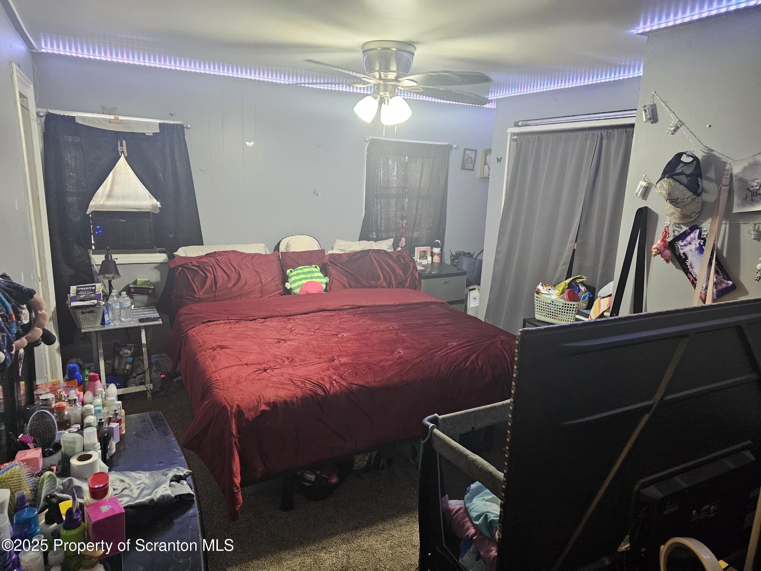 139 Terrace Street Carbondale, PA 18407 - Photo 2 of 9 a bedroom with bed and a chandelier