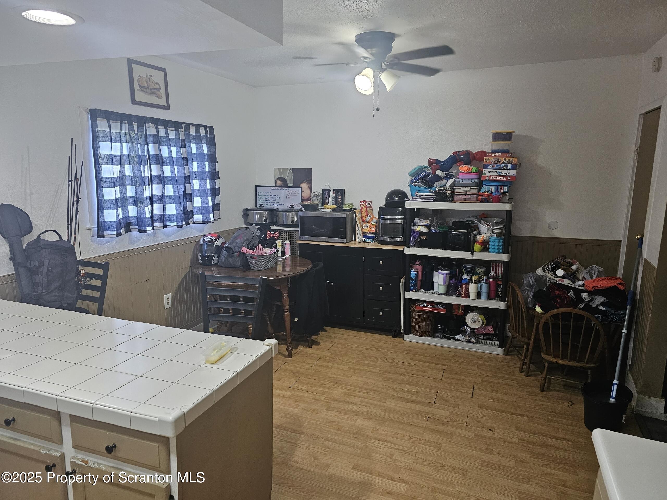 139 Terrace Street Carbondale, PA 18407 - Photo 7 of 9 a kitchen with a stove a refrigerator and a dining table