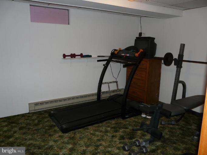791 Hilltop Road Elkton, MD 21921 - Photo 12 of 20 a room with gym equipment and a wooden floor