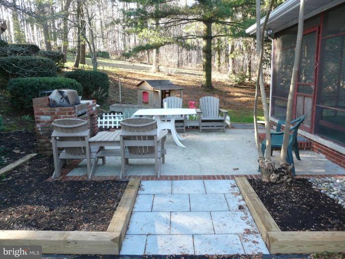 791 Hilltop Road Elkton, MD 21921 - Photo 15 of 20 a view of a patio with table and chairs and potted plants