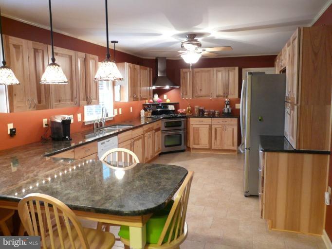 791 Hilltop Road Elkton, MD 21921 - Photo 3 of 20 a kitchen with stainless steel appliances granite countertop a sink a stove and refrigerator