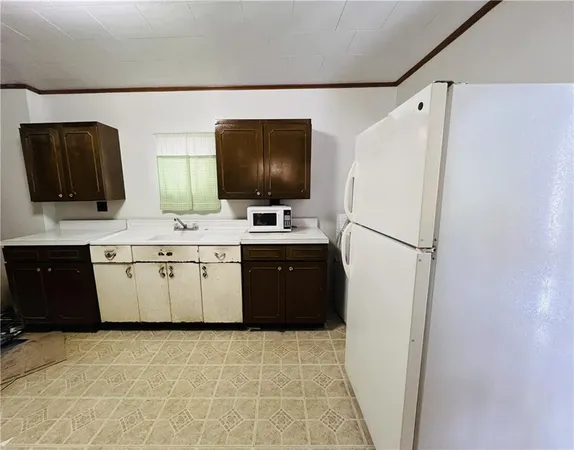a utility room with cabinets washer and dryer