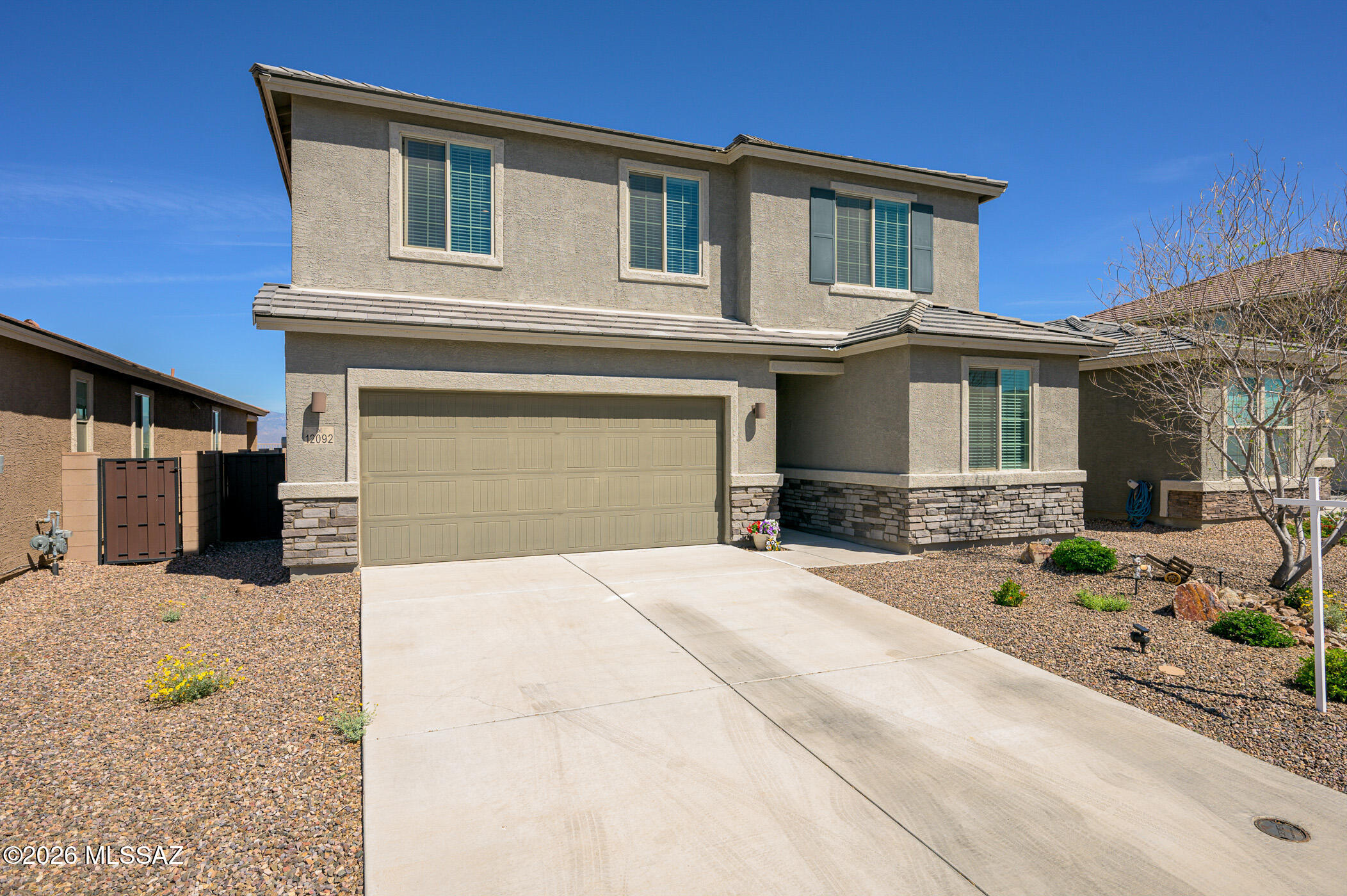 12092 East Ryscott Circle Vail, AZ 85641 - Photo 4 of 49 a front view of a house with potted plants