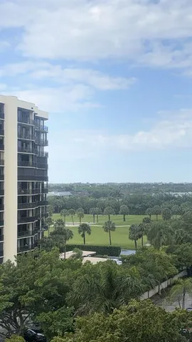 an aerial view of a residential houses with outdoor space and trees