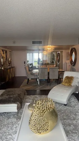 a living room with couches and kitchen view