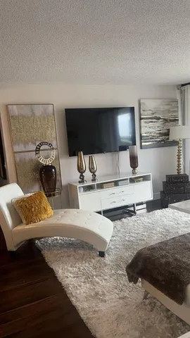 a living room with furniture and a lamp