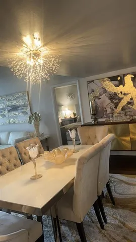 a dining room with furniture and chandelier