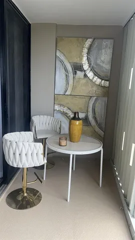 a living room with couches chairs and a table with wooden floor