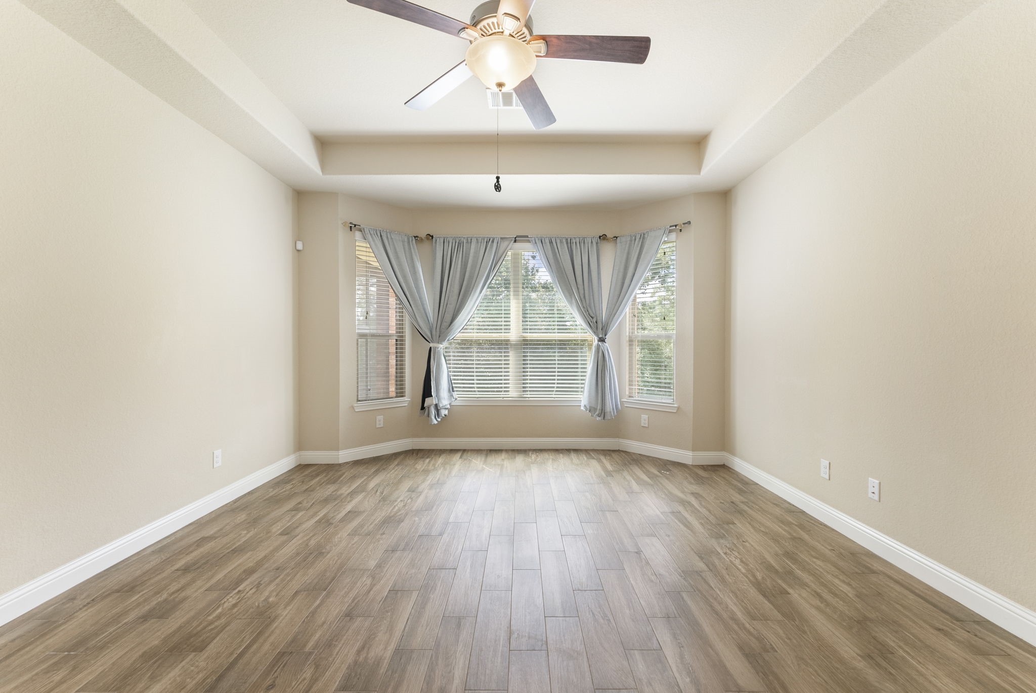 3565 Falcon Way Conroe, TX 77304 - Photo 20 of 50 Spacious primary bedroom with tray ceiling and multiple windows.